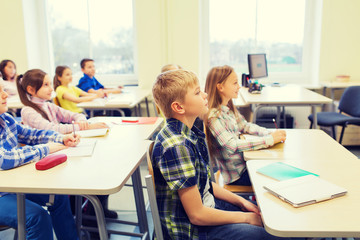 Wall Mural - group of school kids with notebooks in classroom