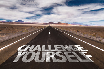 Challenge Yourself written on desert road