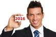 © petrdlouhy - Happy new 2016 year. Handsome smiling businessman in suit shows business card with numeral 2016.