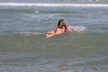 lovely girl at the beach with her bodyboard