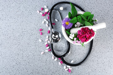 Wall Mural - Alternative medicine herbs and stethoscope on wooden table background