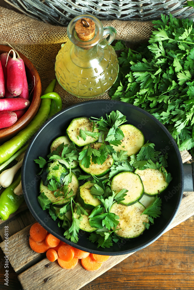 Sliced zucchini in pan on table, top view
