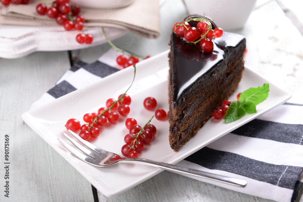 Tasty chocolate cake with berries on table close up