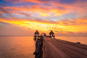 Wall Mural - Wooded bridge in the port and sunset