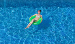 © Sergey Chumakov - sexy brunette woman tanning on inflatable circle in swimming pool