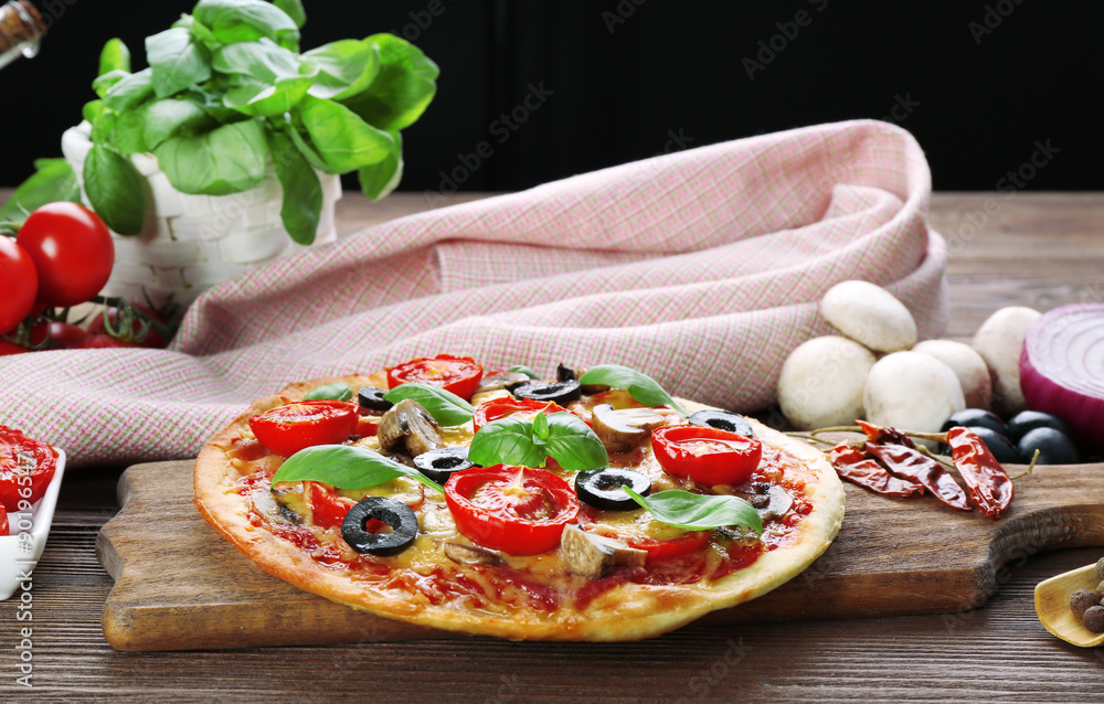 Tasty pizza with vegetables and basil on table close up
