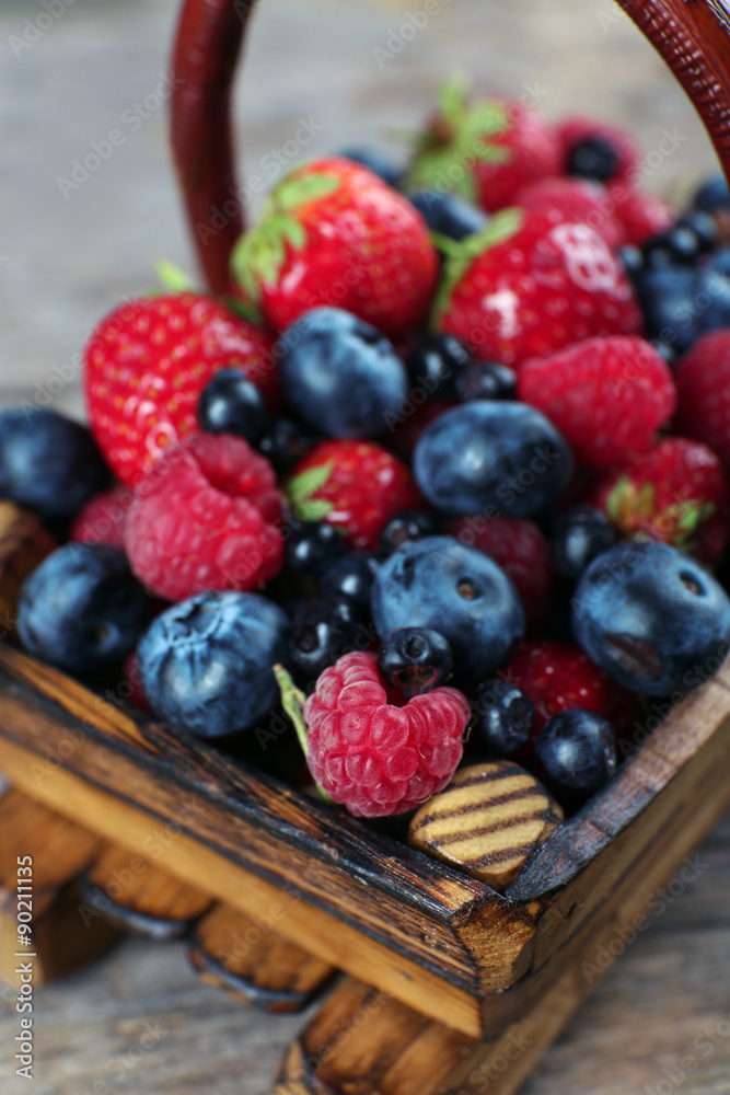 Sweet tasty berries in basket close up