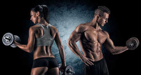 Wall Mural - Athletic man and woman with a dumbells.