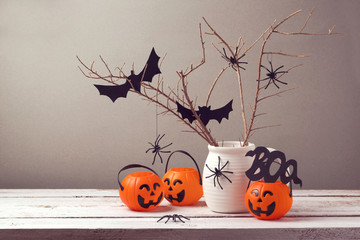 halloween holiday celebration with spiders and pumpkin buckets for trick or treat.