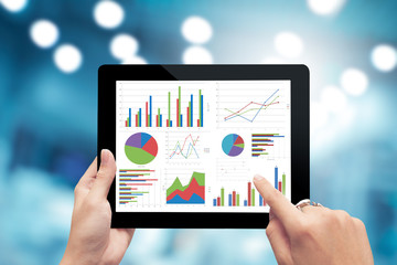 Closeup hand holding digital tablet show analyzing graph