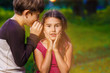 © maxximmm - boy girl whispers in the ear secret rumors says in nature photos