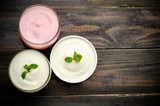 Fototapeta  - Homemade yogurt on wooden background (Top view)