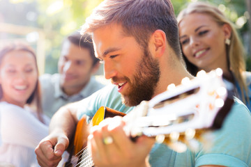 Wall Mural - Friends with guitar having fun