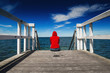 Alone Woman in Red Shirt at the Edge of Jetty
