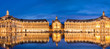 Panoramic view of Place la Bourse in Bordeaux, reflections in the water mirror illuminated at night, France