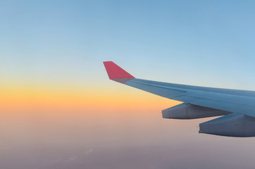 Wall Mural - wing of airplane and sunrise sky