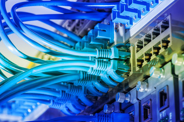 network cables and hub closeup with fiber optical background