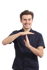 Attractive happy man gesturing time out