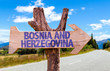 Bosnia and Herzegovina wooden sign with road background