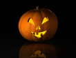 Halloween pumpkin on a black reflective surface