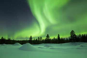 aurora borealis over snowy winter landscape, finnish lapland