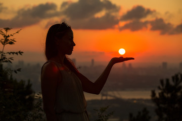 Single adult woman silhouette at sunset