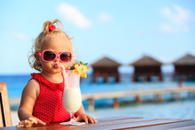 Cute Little Girl Drinking Cocktail On Tropical Beach