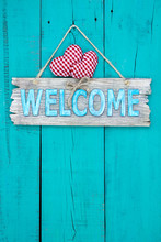 Welcome Sign With Hearts Hanging On Teal Blue Door