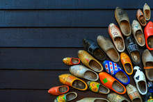 Colorful Wooden Clogs On Dark Wooden Panels