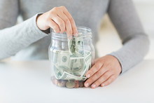 Close Up Of Woman Hands And Dollar Money In Jar
