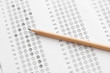 © somkanokwan - Standardized test form with answers bubbled in and a pencil, foc