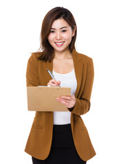 Wall Mural - Asian young businesswoman take note on clipboard