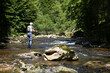 © goodluz - Fly-fisherman fishing in river on summer season