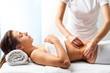 © karelnoppe - Therapist doing healing massage on female abdomen.