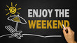 © cacaroot - enjoy the weekend concept on blackboard