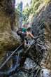 Man backpacker going down in a gorge