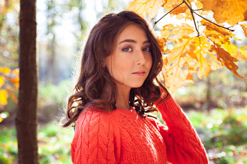 Young girl in beautiful autumn park