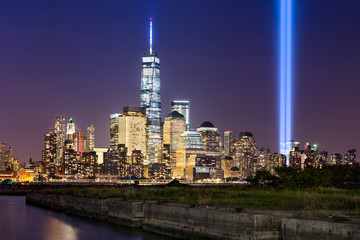 Wall Mural - New York City Tribute in Light. The annual commemoration of September 11th in Lower Manhattan adjacent to the new World Trade Center. Two vertical columns of light rise above the Financial District.