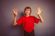 © maxximmm - European-looking boy of ten years shows a figure eight finger on