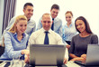 © Syda Productions - smiling business people with laptop in office