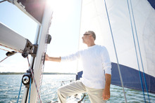 Senior Man On Sail Boat Or Yacht Sailing In Sea