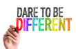 Hand with marker writing the word Dare To Be Different