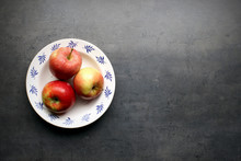 Fresh Apples On Plate With Copyspace On Grey Kitchen Table