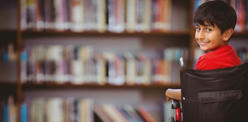 Composite image of boy sitting in wheelchair in school