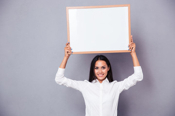 Sticker - Portrait of a happy woman holding blank board on head