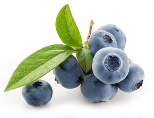 Wall Mural - Ripe berries in the wooden bowl over green grass.