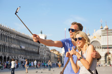 Tourists Using Selfie Stick To Make Photo With Smartphone
