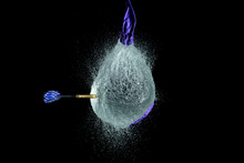 Balloon Filled With Water Is Popped With Dart To Make A Mess