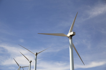 eolic wind turbines on a modern windmill farm for alternative energy generation