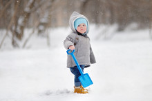 Beautiful Toddler Boy Playing With Snow
